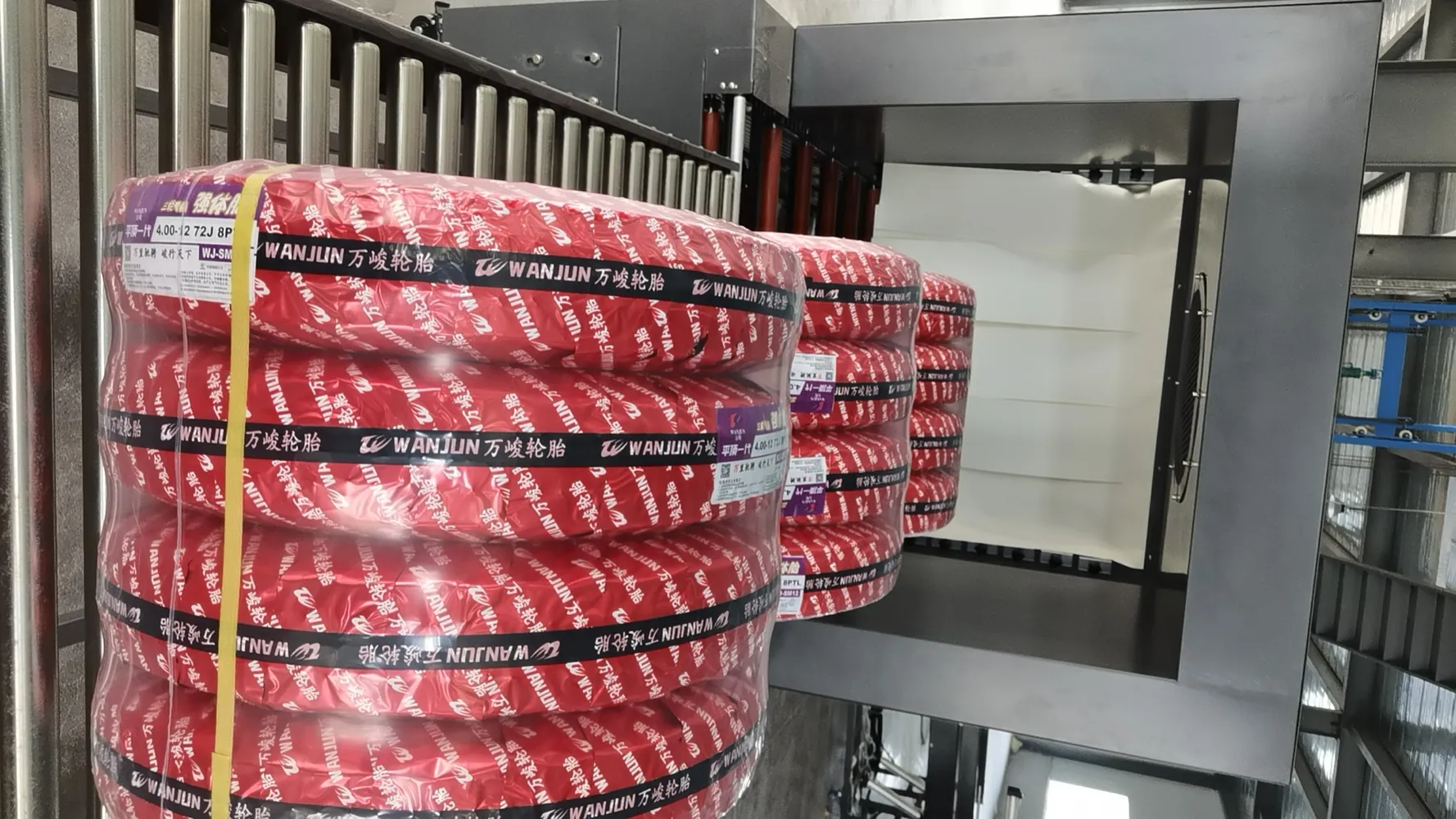 Tire with shrink film and branded strap