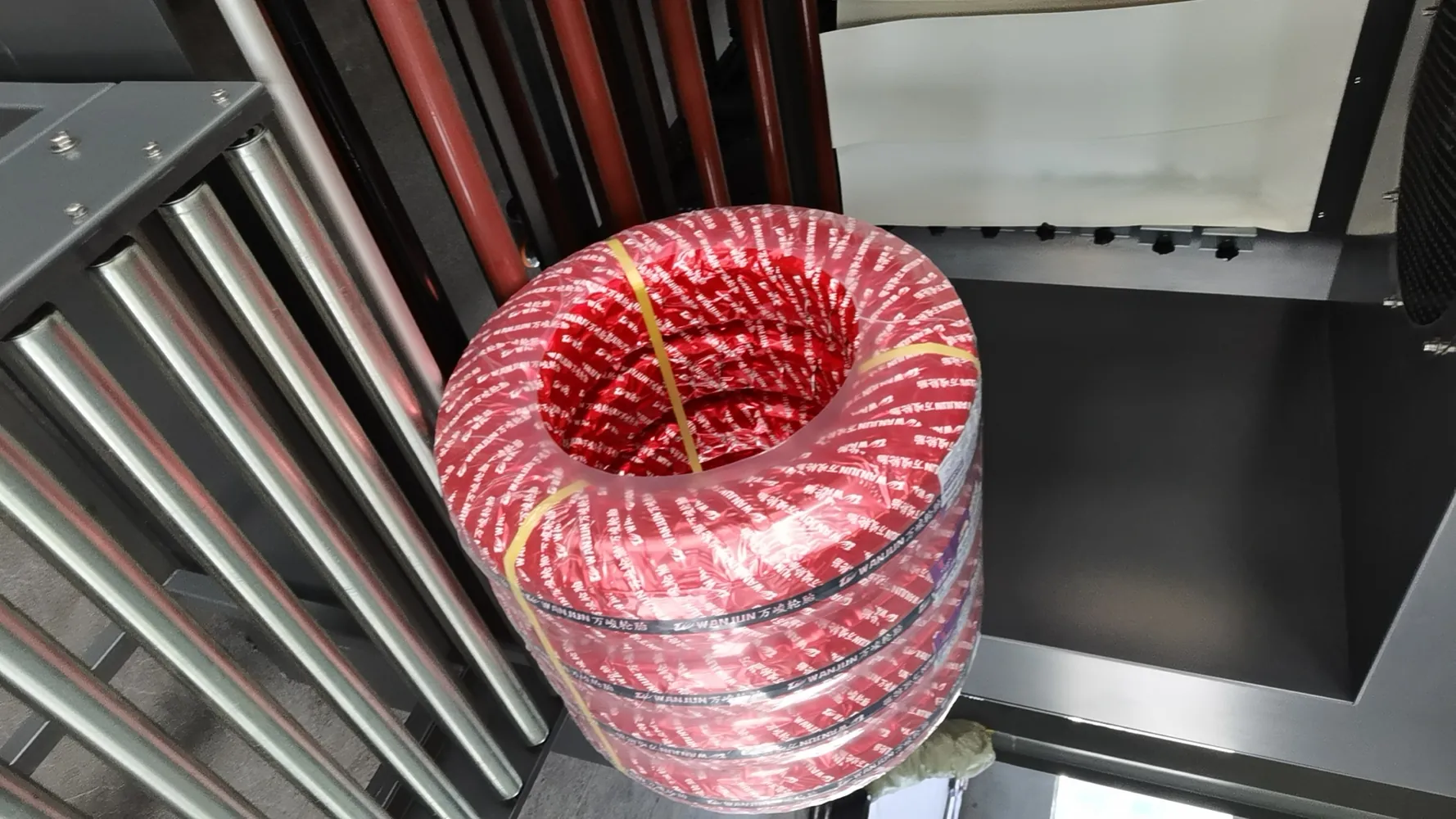 Tire bundles entering shrink tunnel